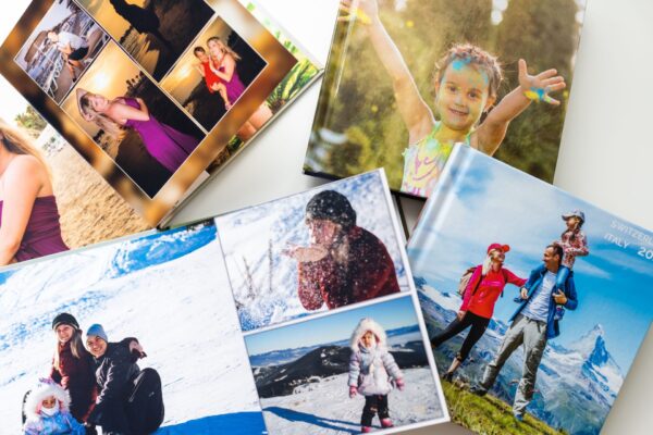 Collage of custom 10x10 lay-flat photo books showcasing beautifully designed family yearbooks with premium layouts and vibrant colors.